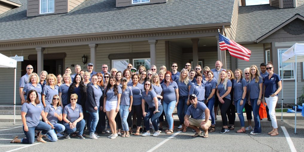 The Whole Windermere Group One Team Posing in Front of the Office.